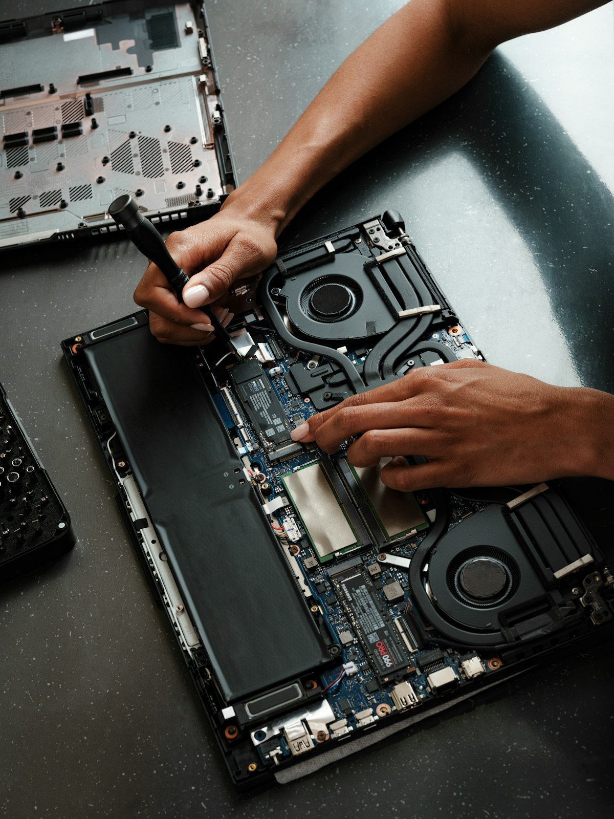 A technician repairing a laptop
